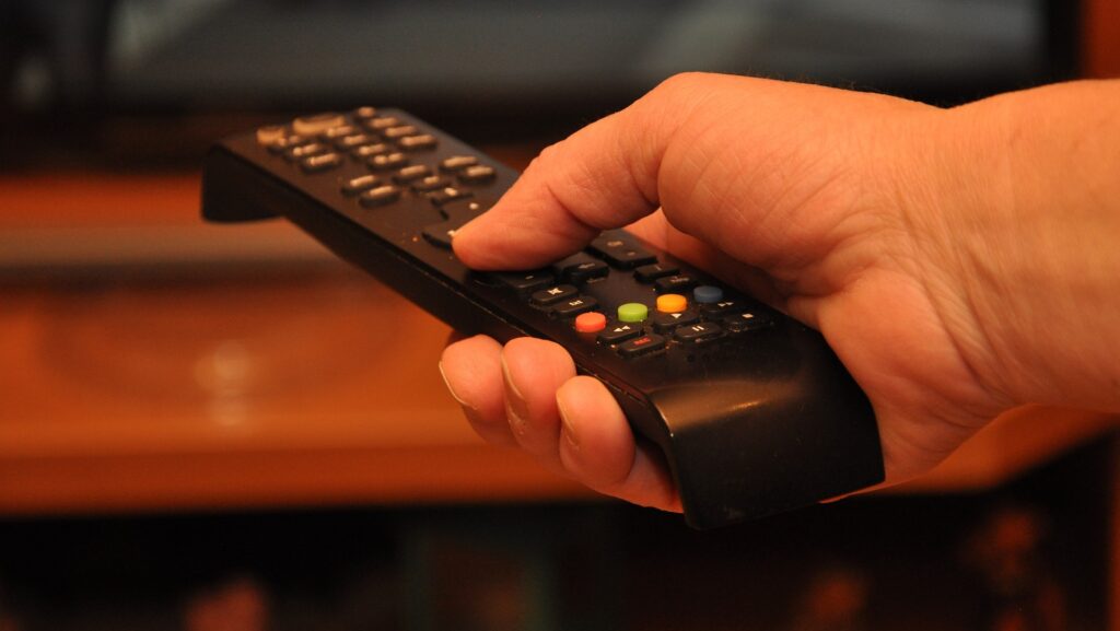 Hand holding remote control