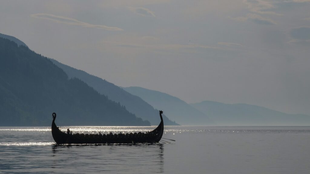 A long boat on a large body of open water.
